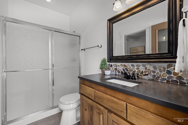 bathroom with vanity, a shower with shower door, tile patterned floors, and toilet