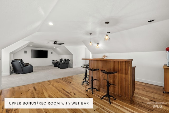 bonus room with lofted ceiling and light hardwood / wood-style flooring