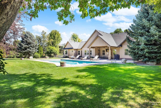 view of pool featuring a yard, ceiling fan, and a patio area