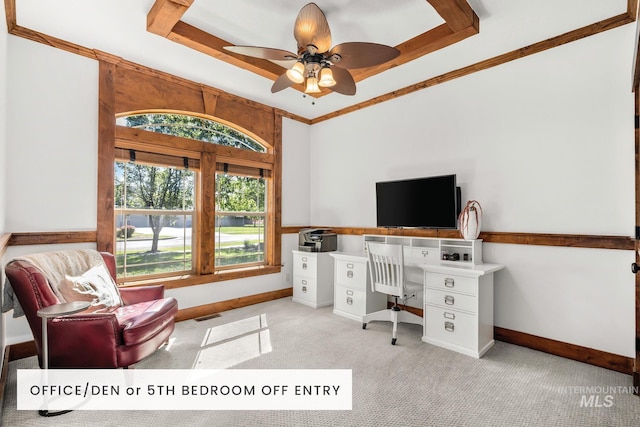 office space with crown molding, ceiling fan, a tray ceiling, and light carpet