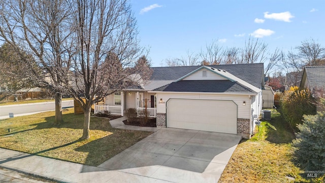 ranch-style house featuring cooling unit, a garage, a front yard, and covered porch