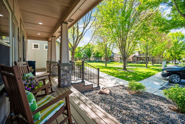 wooden deck with a lawn and a residential view