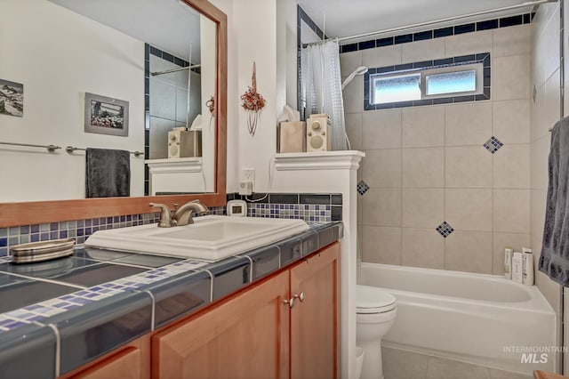 full bath with tile patterned floors, toilet, backsplash, shower / tub combo, and vanity