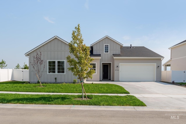 view of front facade with a garage and a front lawn