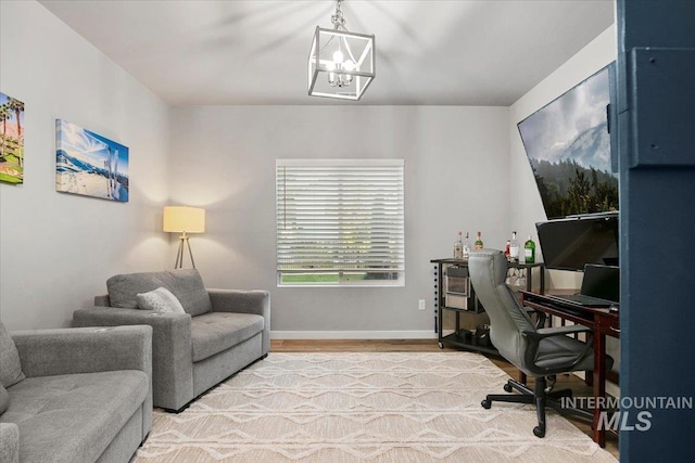 office space featuring light hardwood / wood-style floors and an inviting chandelier