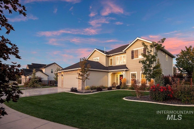 view of front of home featuring a lawn and a garage