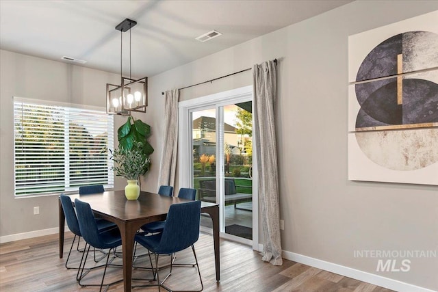 dining space featuring a notable chandelier and light hardwood / wood-style flooring