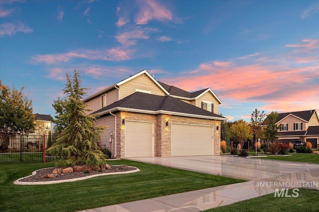 view of front of home featuring a lawn and a garage