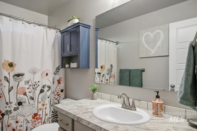 bathroom with toilet and vanity