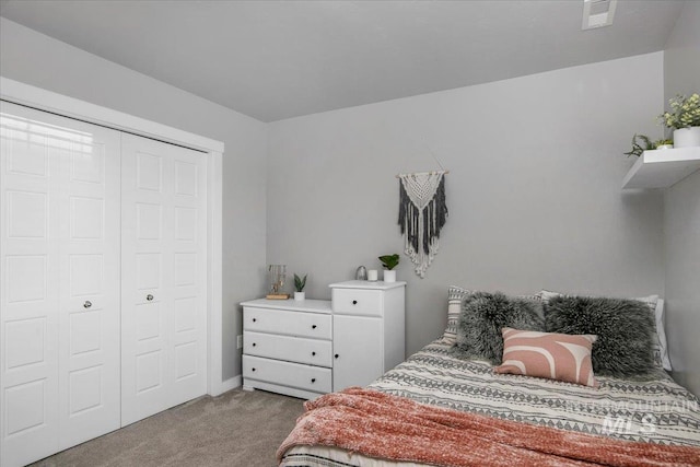 bedroom featuring light colored carpet and a closet