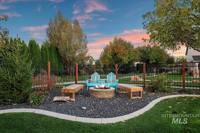 exterior space with a yard and a fire pit