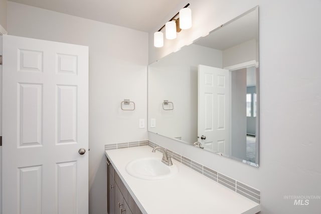 bathroom with tasteful backsplash and vanity