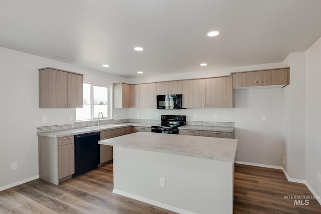 kitchen featuring a kitchen island, black appliances, wood-type flooring, sink, and light brown cabinetry