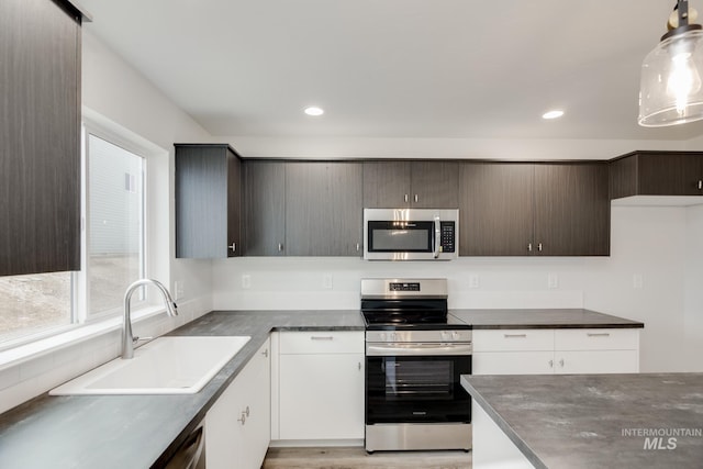 2219 W Cascara St, Kuna, ID 83634 - kitchen featuring light brown cabinets, light countertops, a sink, and black appliances