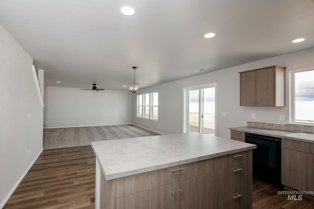 kitchen with dishwasher, a center island, dark hardwood / wood-style flooring, and a wealth of natural light