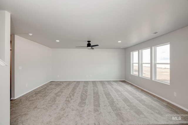 unfurnished room featuring light carpet and ceiling fan