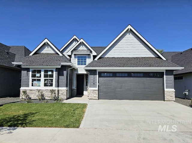 view of front of house with a garage and a front lawn