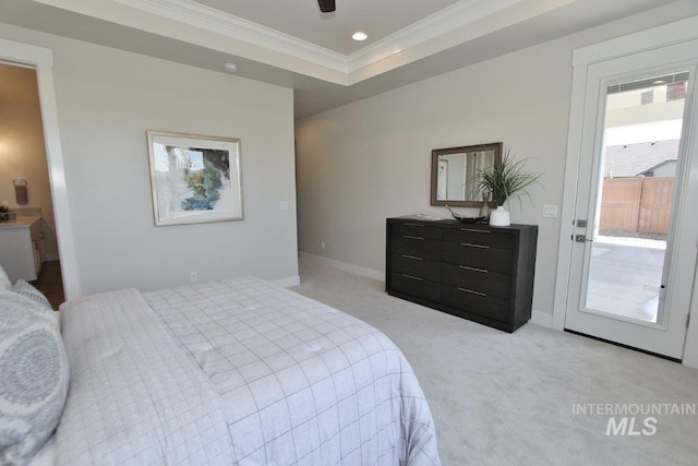 carpeted bedroom with ceiling fan, ornamental molding, and a raised ceiling