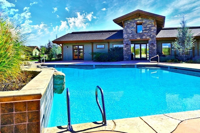 view of pool featuring french doors