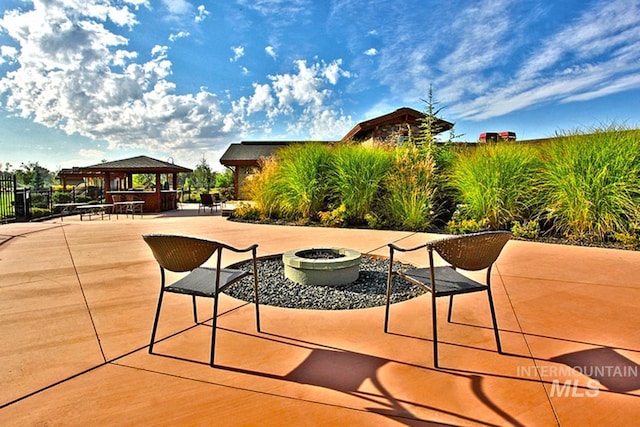 view of patio with an outdoor fire pit and a gazebo