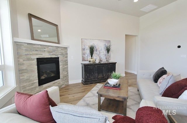 living room with light hardwood / wood-style floors and a fireplace