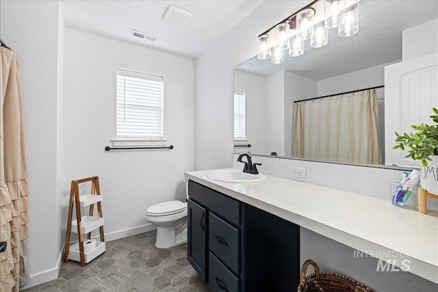 full bath with vanity, toilet, baseboards, and visible vents