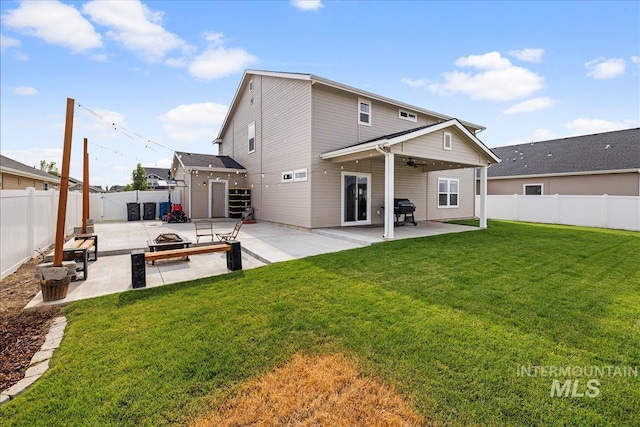 rear view of property with a patio, a fenced backyard, a lawn, and ceiling fan