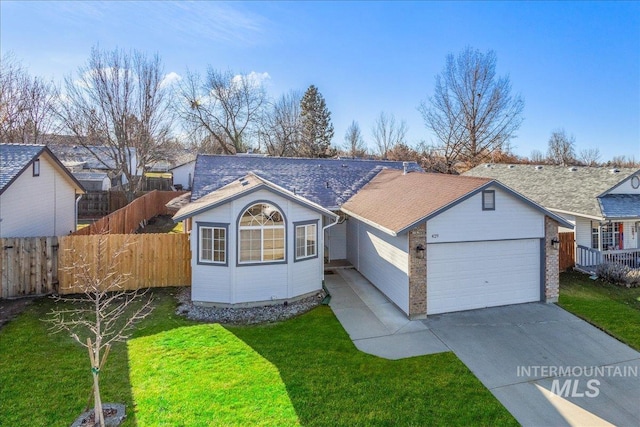 single story home featuring a garage and a front yard