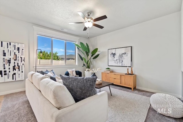 2252 E Tiger Lily Dr, Boise, ID 83716 - carpeted living room featuring a ceiling fan, baseboards, and a textured ceiling