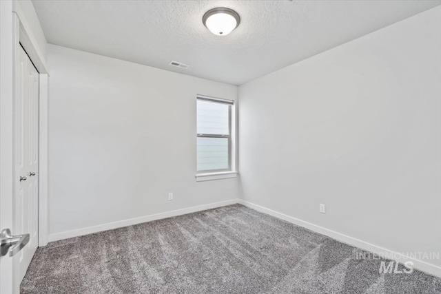 2252 E Tiger Lily Dr, Boise, ID 83716 - unfurnished bedroom featuring a textured ceiling, carpet flooring, baseboards, and a closet