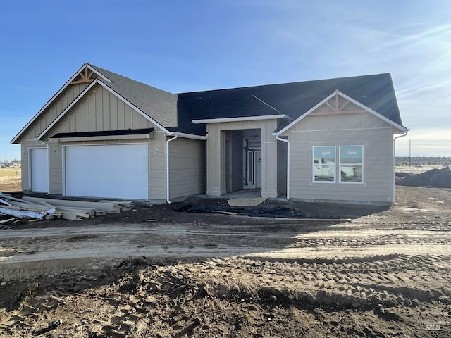 property under construction featuring an attached garage and board and batten siding