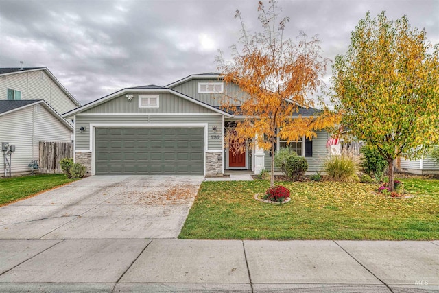 view of front of property featuring stone siding, an attached garage, concrete driveway, and board and batten siding