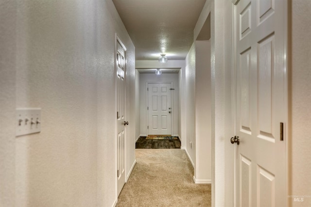 corridor featuring carpet floors and baseboards