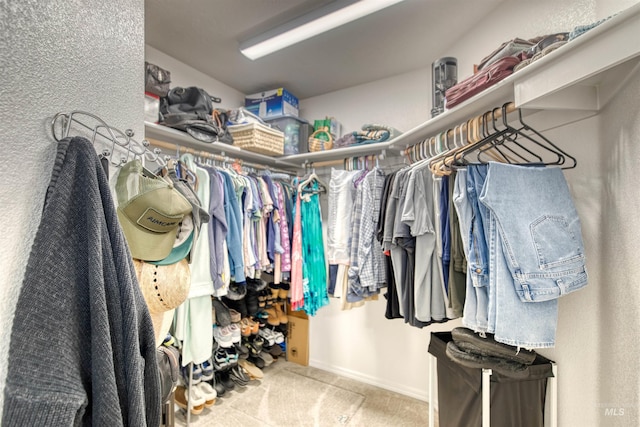 walk in closet featuring carpet flooring