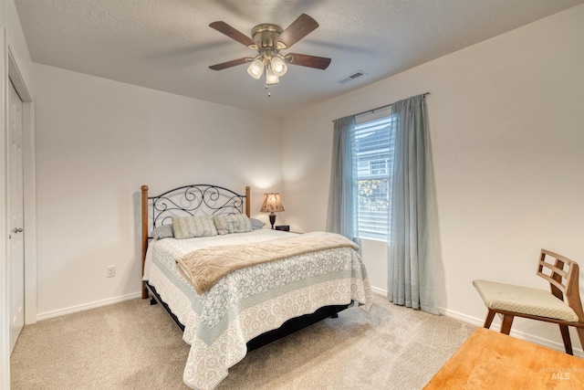 bedroom with light colored carpet, baseboards, and ceiling fan