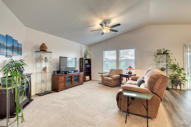 living room featuring vaulted ceiling and a ceiling fan