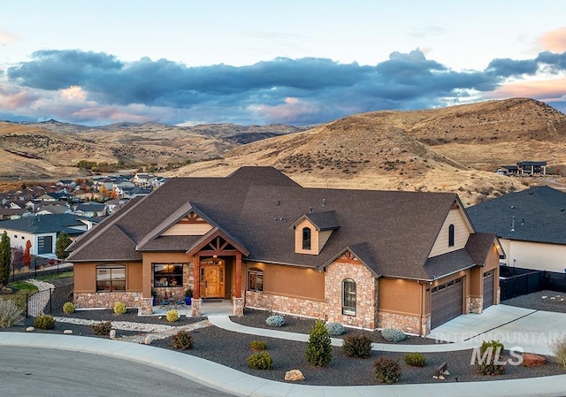 view of front of property with a garage and a mountain view