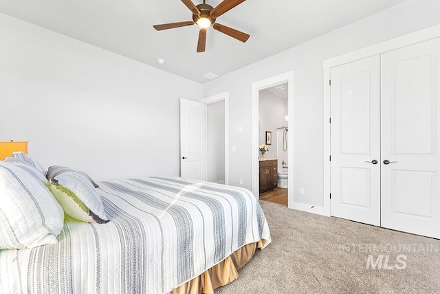 bedroom with ceiling fan, ensuite bath, carpet floors, and a closet