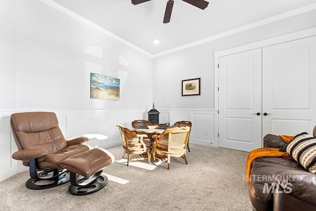 interior space featuring crown molding, ceiling fan, and carpet