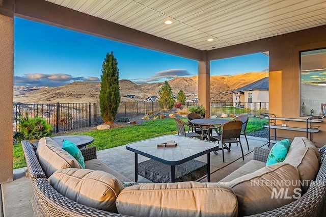 view of patio featuring an outdoor living space and a mountain view