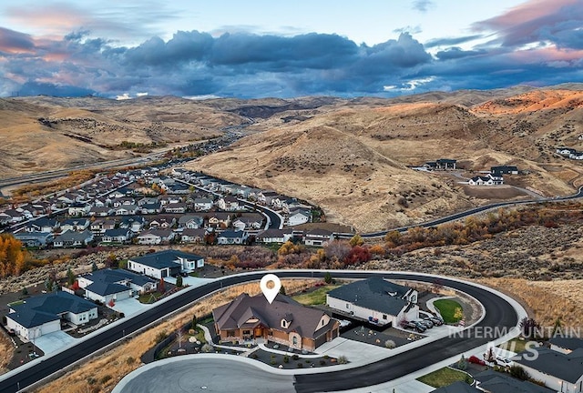 aerial view at dusk featuring a mountain view