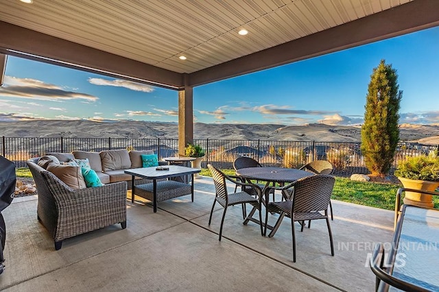 view of patio / terrace with a mountain view and outdoor lounge area