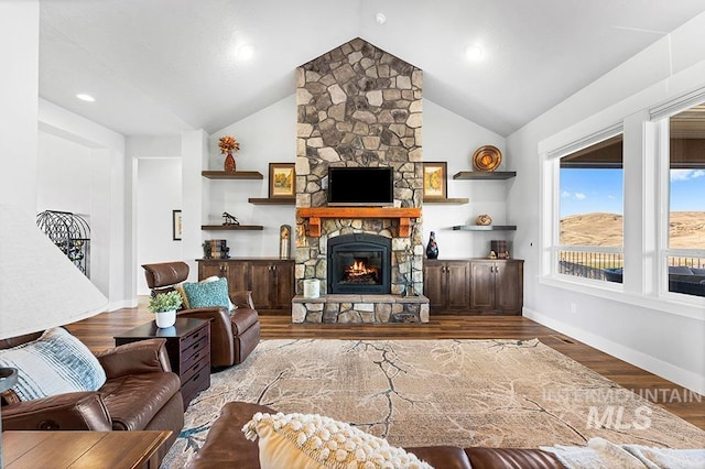 living room with a fireplace, high vaulted ceiling, and light wood-type flooring