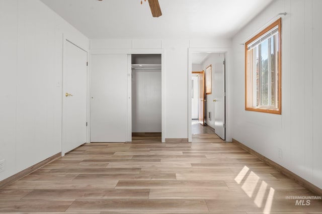 unfurnished bedroom featuring a closet, light wood-style floors, and ceiling fan