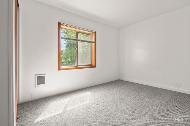 carpeted empty room with heating unit