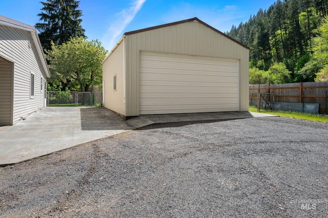 detached garage featuring fence
