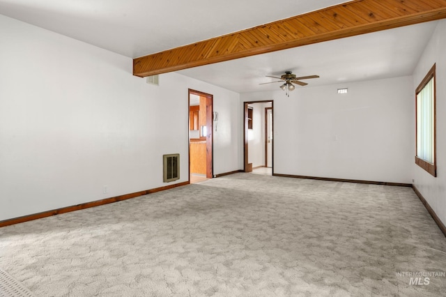 empty room with baseboards, ceiling fan, visible vents, and carpet floors