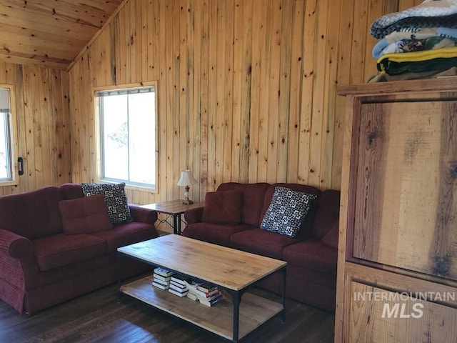 living area with a wealth of natural light, wooden walls, wood finished floors, and vaulted ceiling