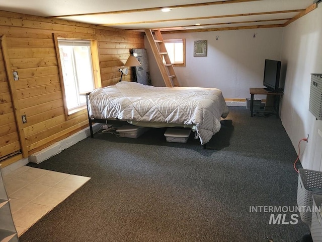 bedroom with wooden walls and carpet flooring