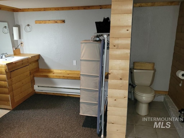 bathroom with vanity, toilet, and a baseboard radiator